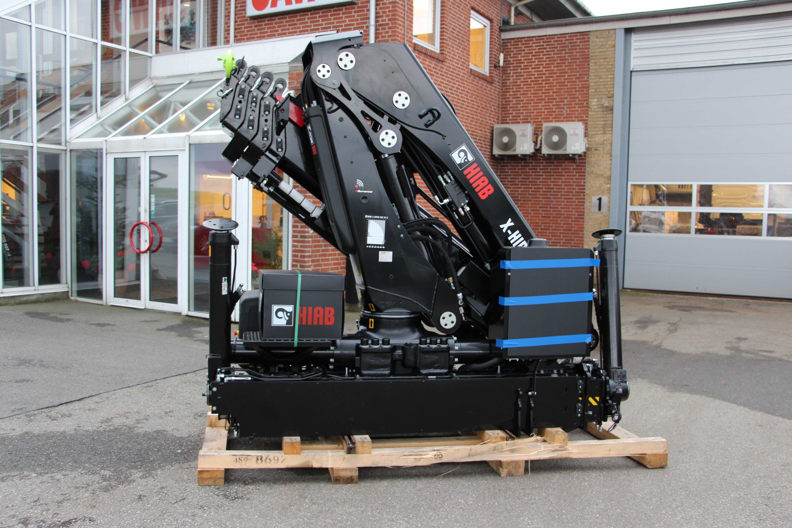 Folded HIAB cranes displayed on pallets