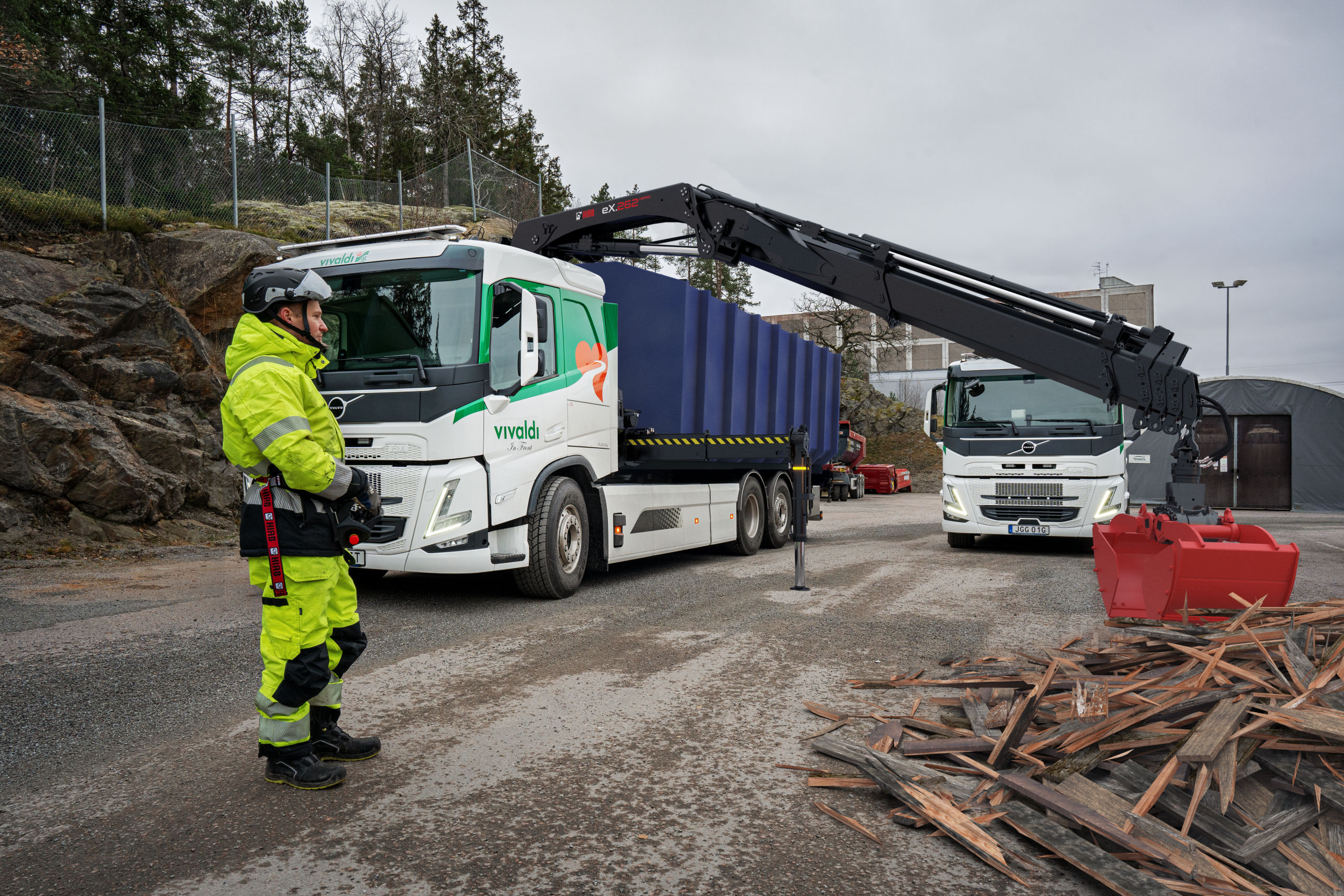 Truck-mounted HIAB crane unloading on a work site